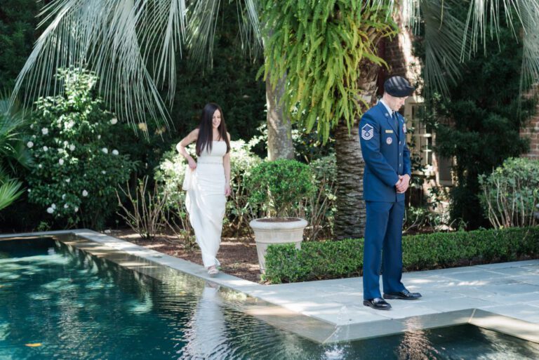 couple's first look on their wedding day by side of pool