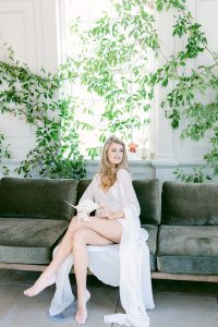 bride sitting on couch reading her vow book