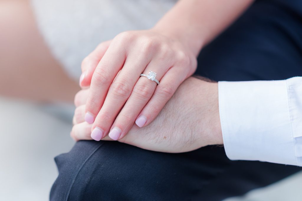 engaged couple holds hands