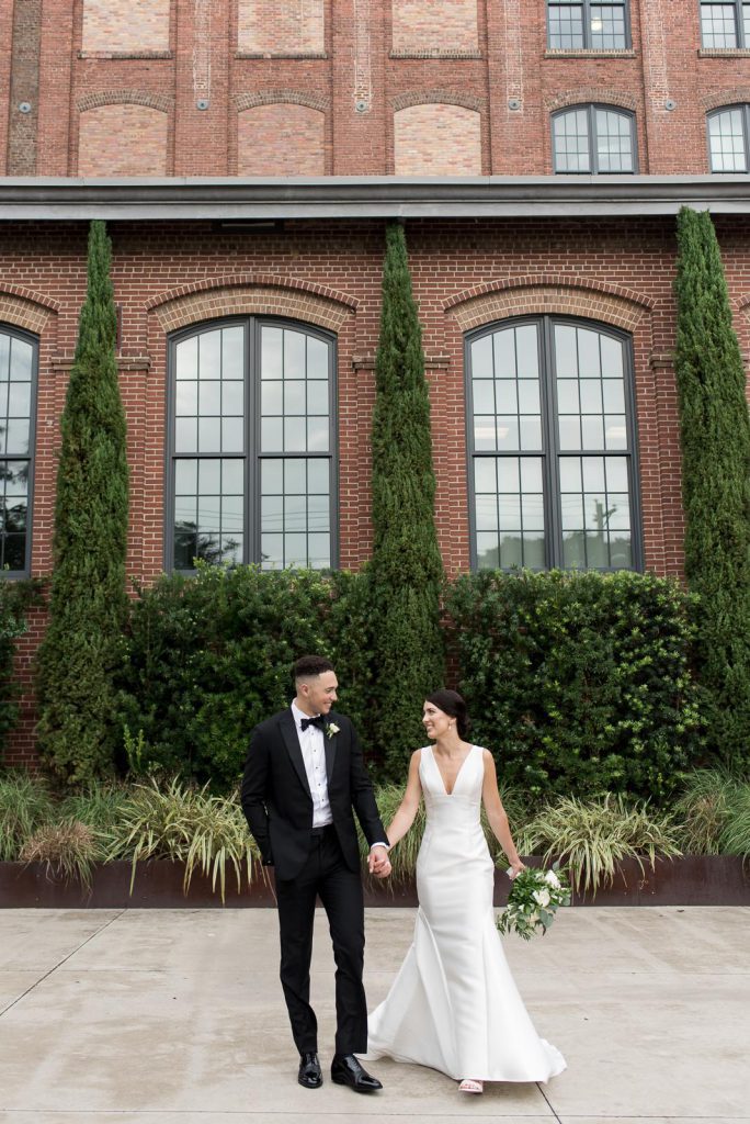 wedding portraits in front of brick exterior at The Cedar Room