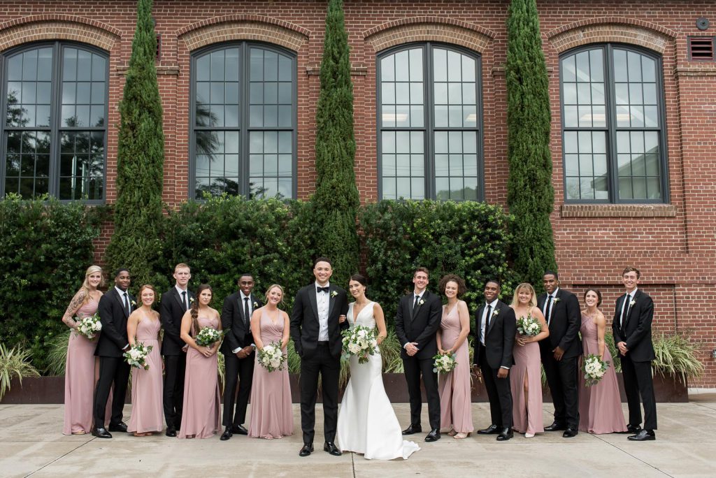 wedding party in front of brick exterior at The Cedar Room