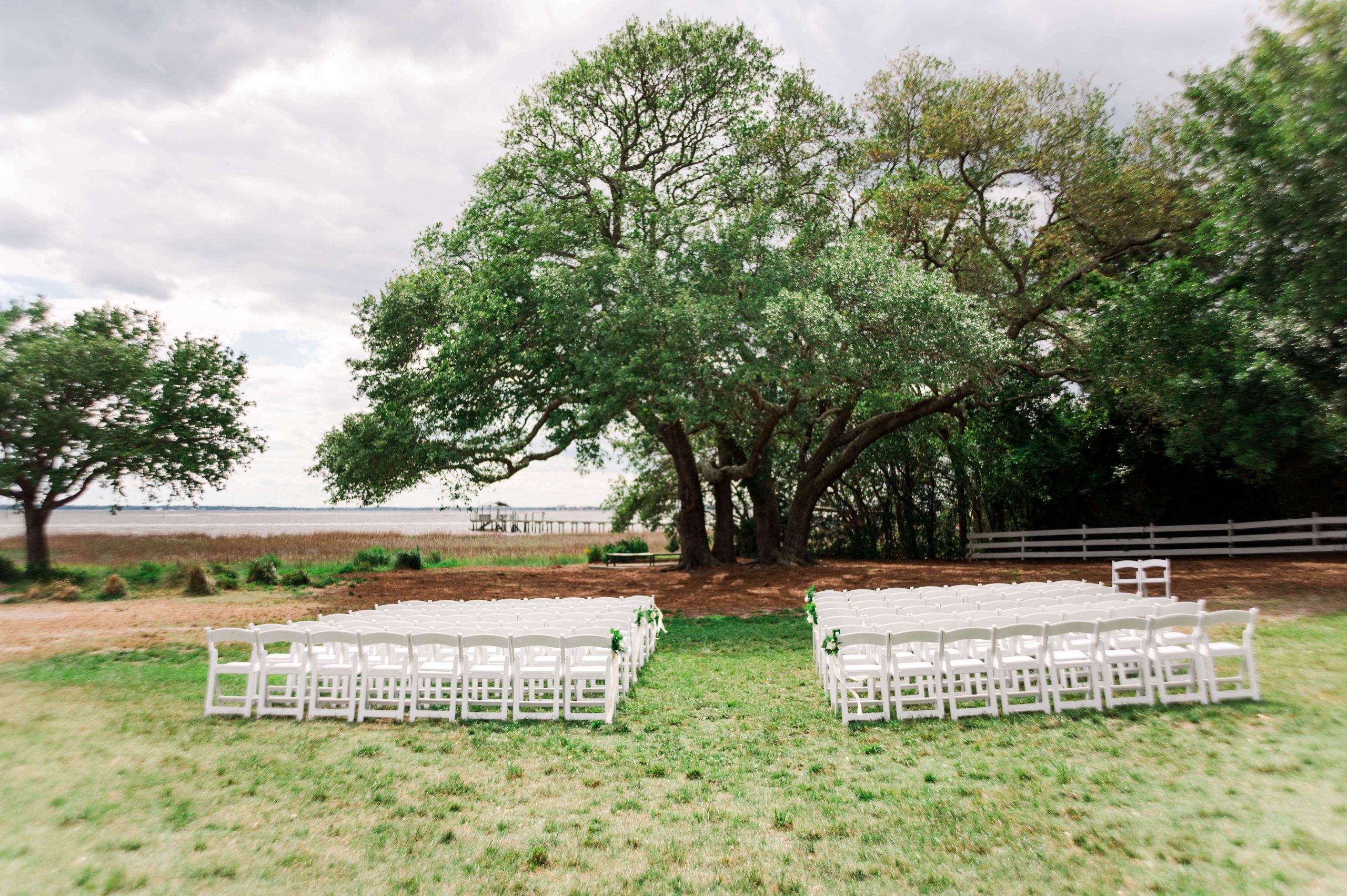 Outside Wedding ceremony set up under large tree