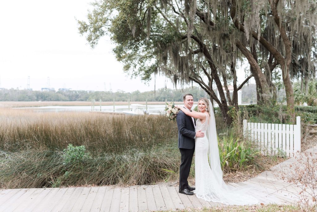 newlyweds embrace on boardwalk
