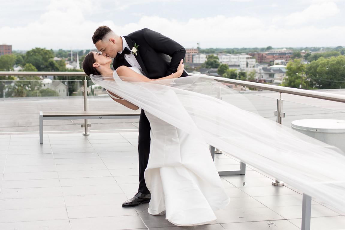 Groom dipping bride on Cedar Room rooftop
