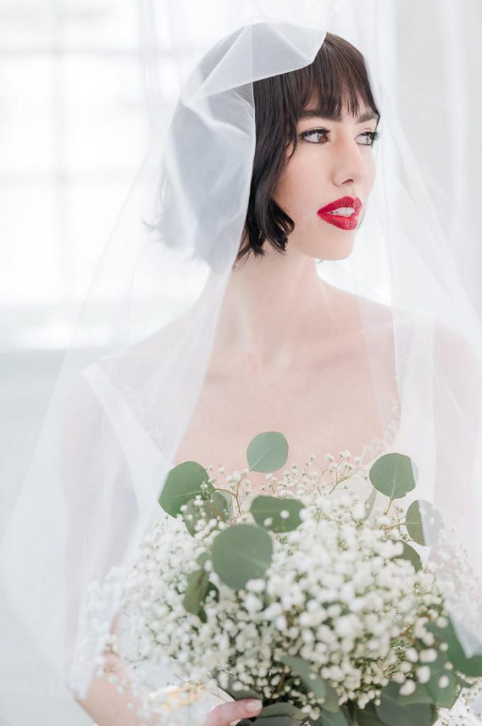 bridal portrait of brunette bride with veil over her head