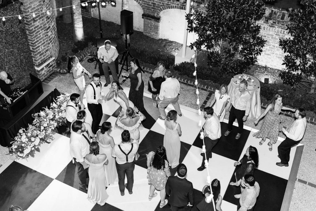 overview of wedding reception black and white dance floor outisde