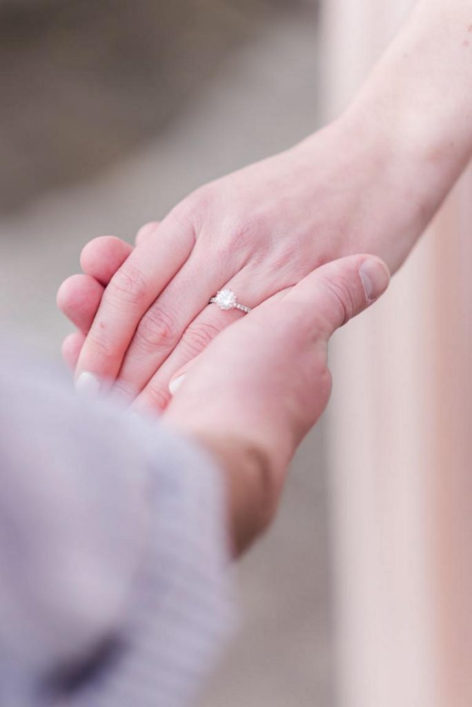 Close up of girl's hand with engagement ring