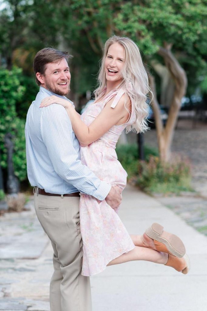 Guy swinging girl off her feet