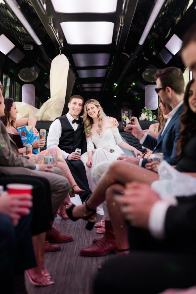 Interior photo of bride groom and friends on party bus