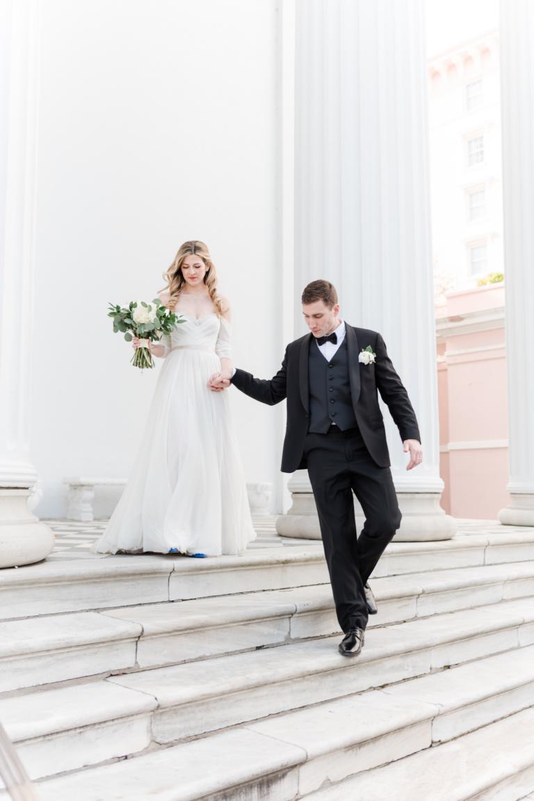 groom leading bride down stairs