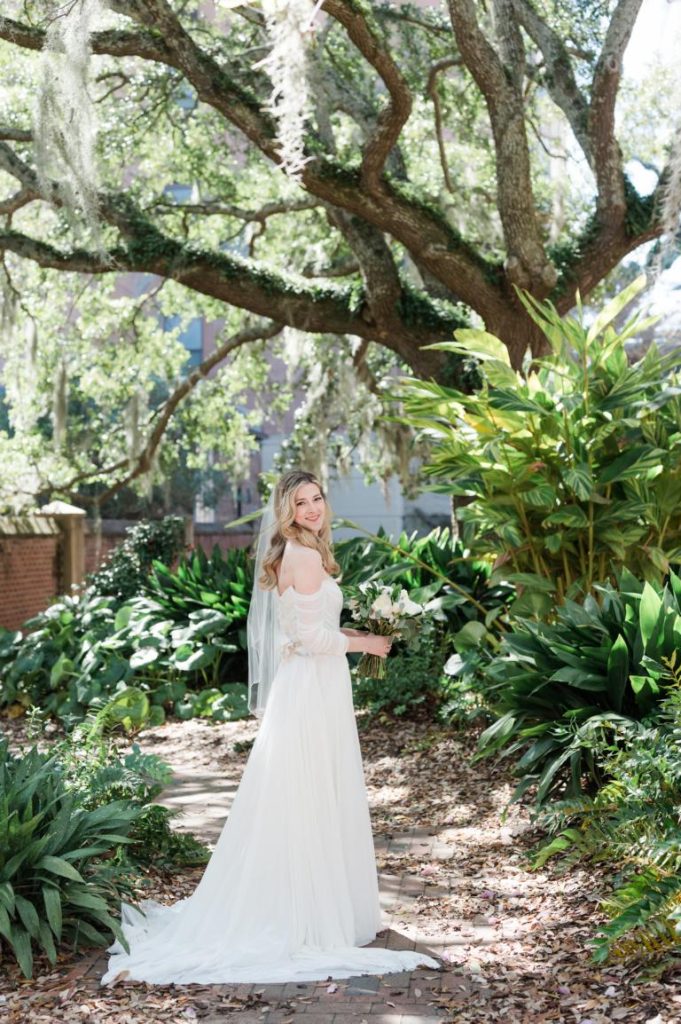 Bride standing on her side in St. Luke's Chapel garden