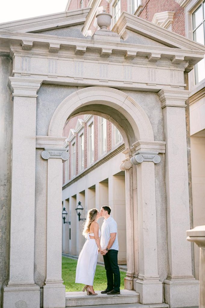 couple kissing under arched doorway