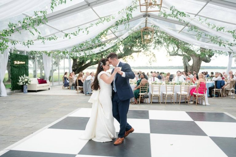 Newlyweds first dance inside clear tented reception