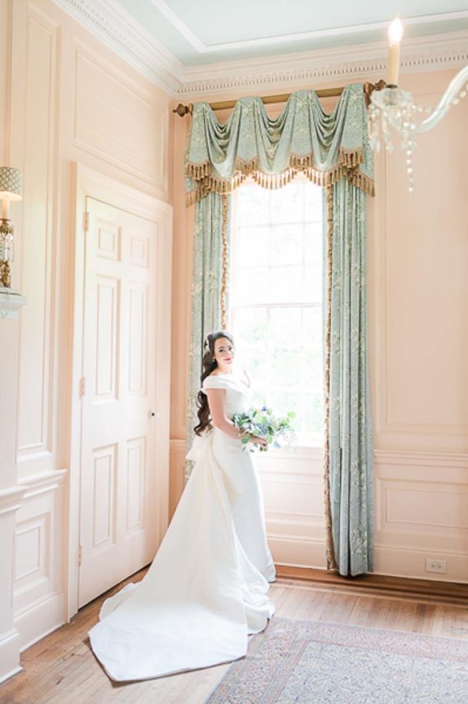 bride standing next to period window treatment in Lowndes Grove House