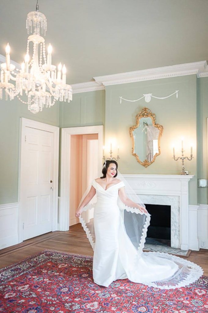 bridal portrait in front of fireplace inside Lowndes Grove