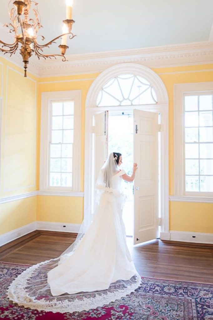 bride opening door to top balcony at Lowndes Grove House