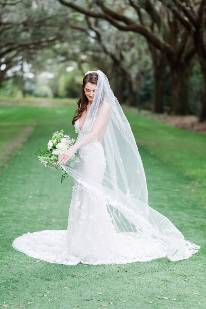 bride swishing veil around her