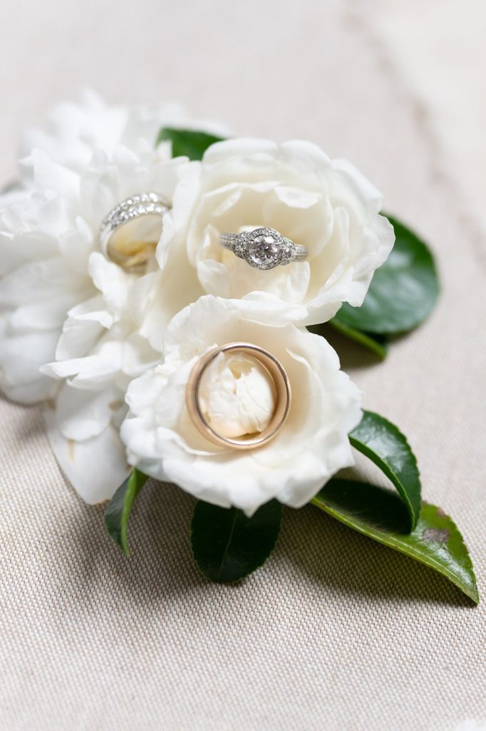 wedding rings nestled in white camellia flower