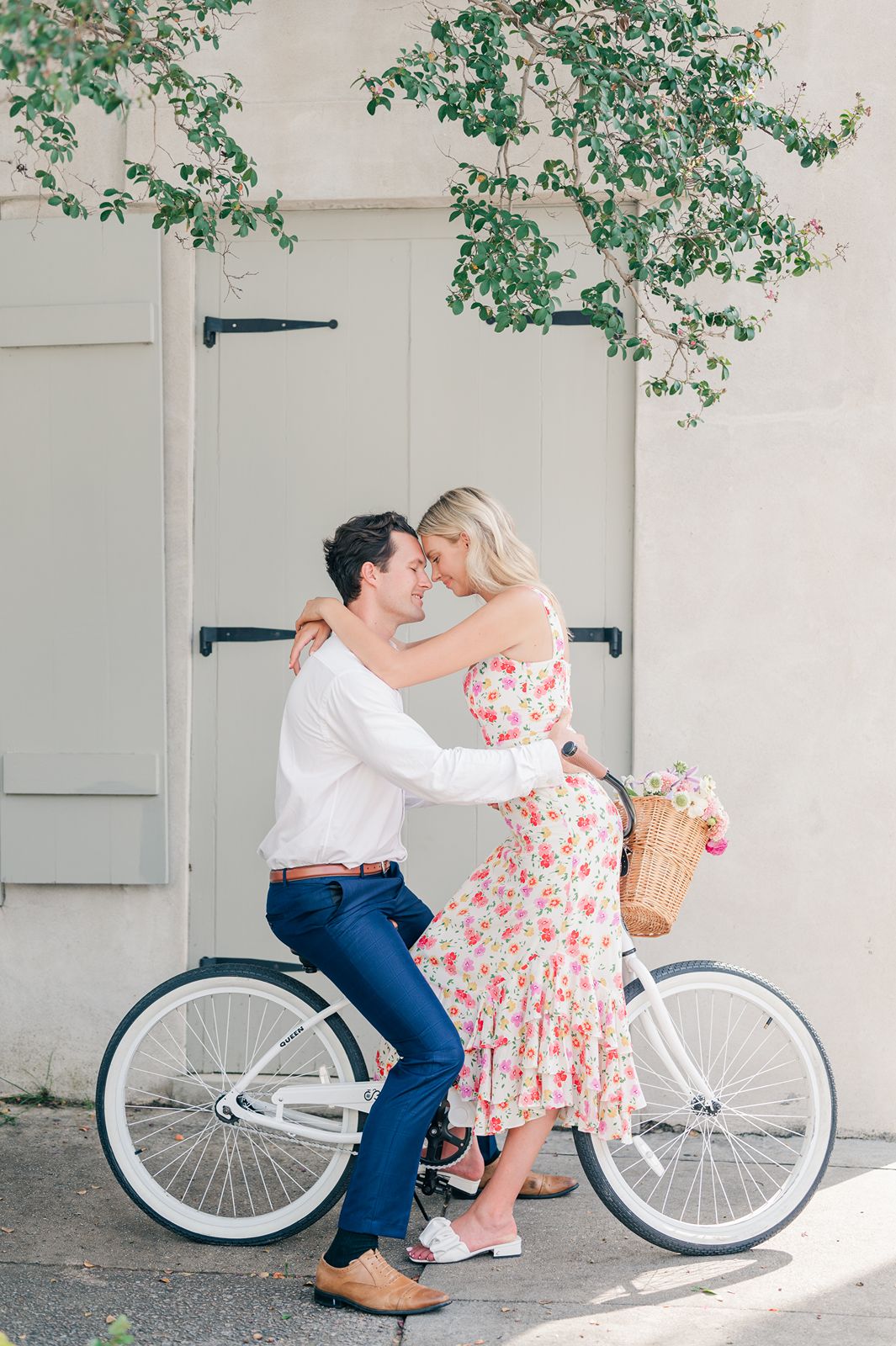 a couple sit on bicycle facing each other forehead to forehead