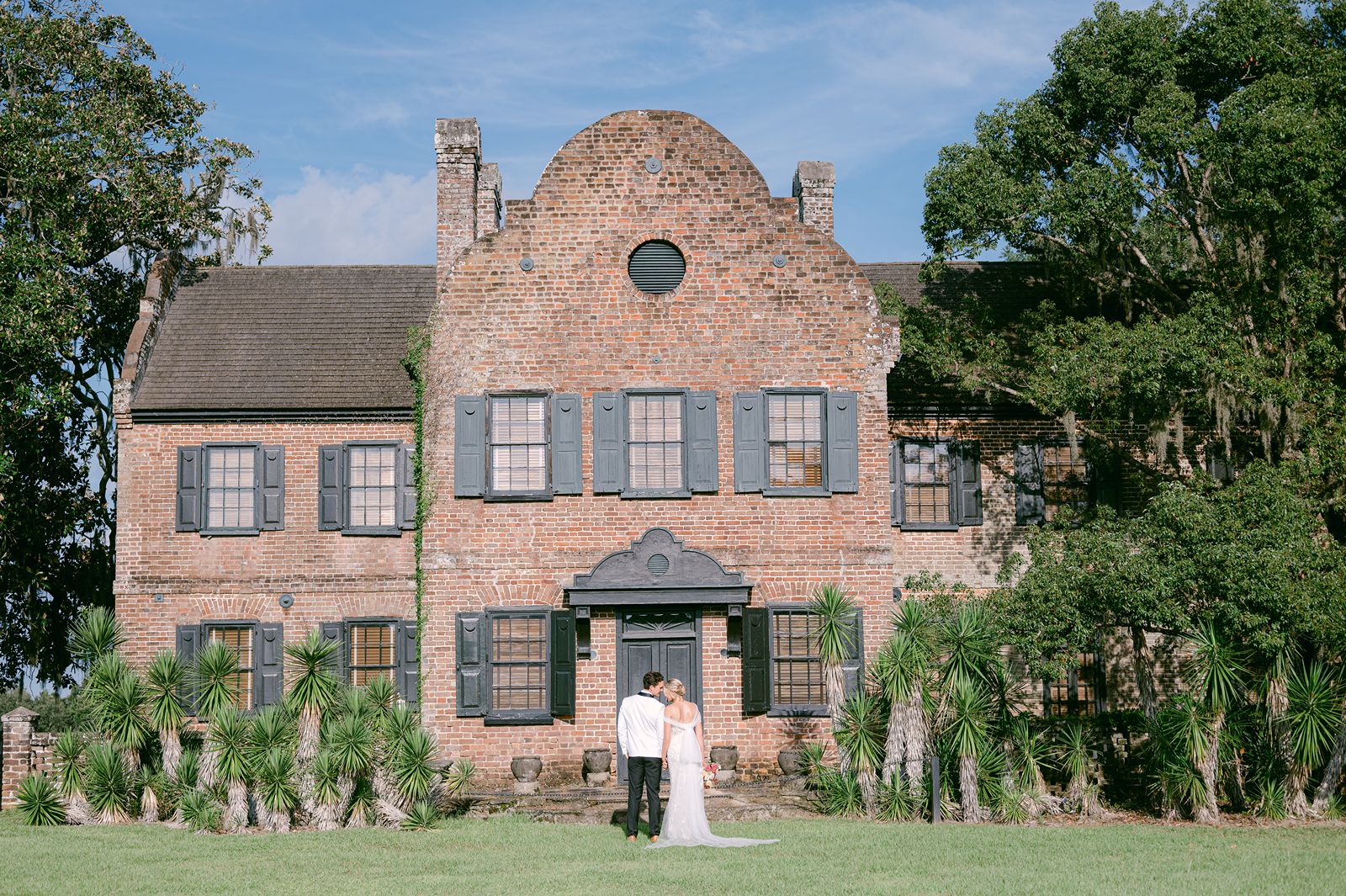 newlyweds stand in front of historic Middle Place home