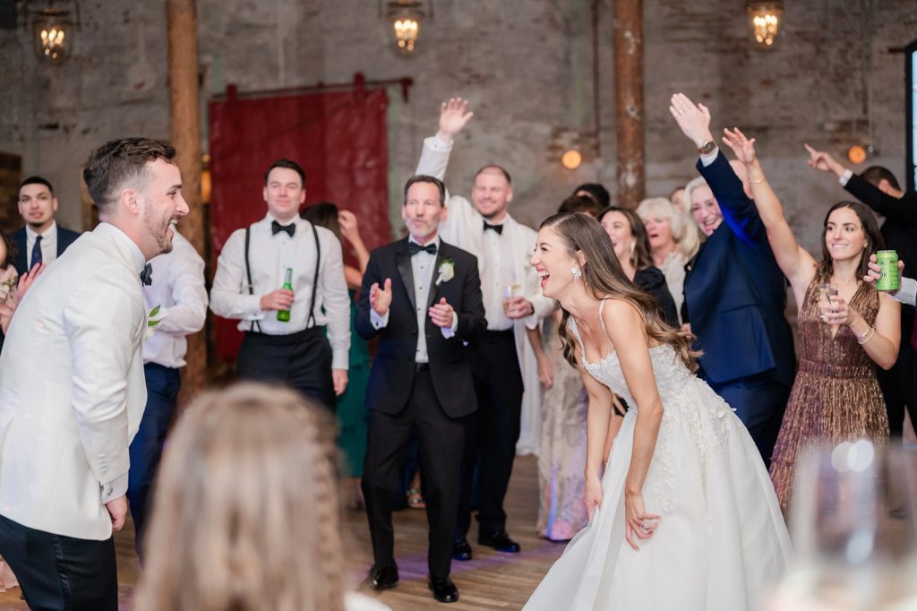 Bride and groom laugh at each other during first dance