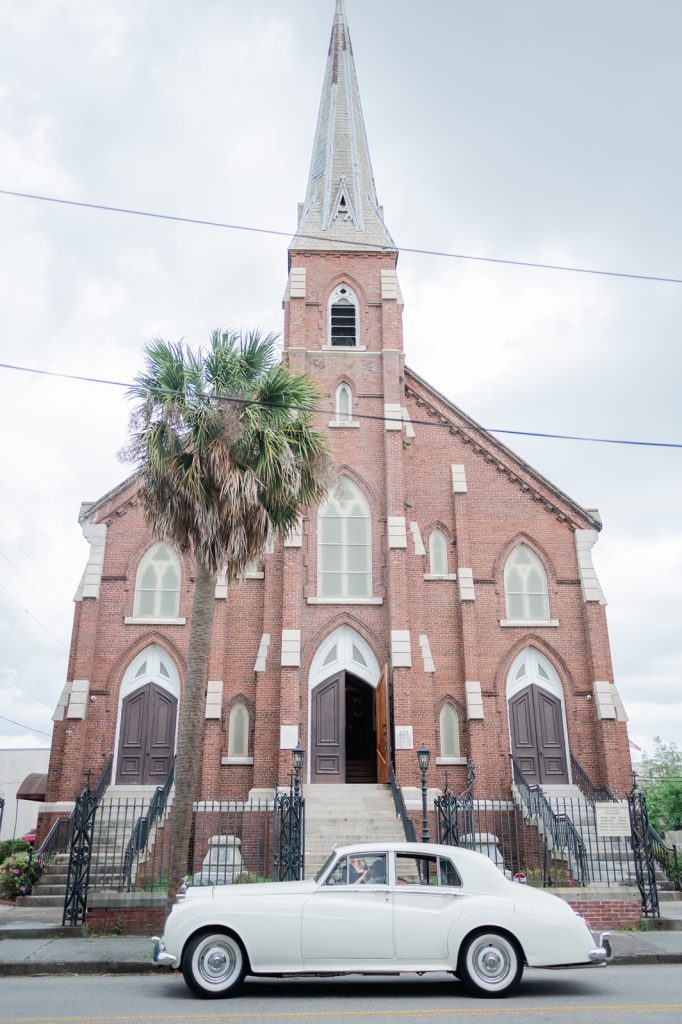 White Rolls-Royce-parked in front of church