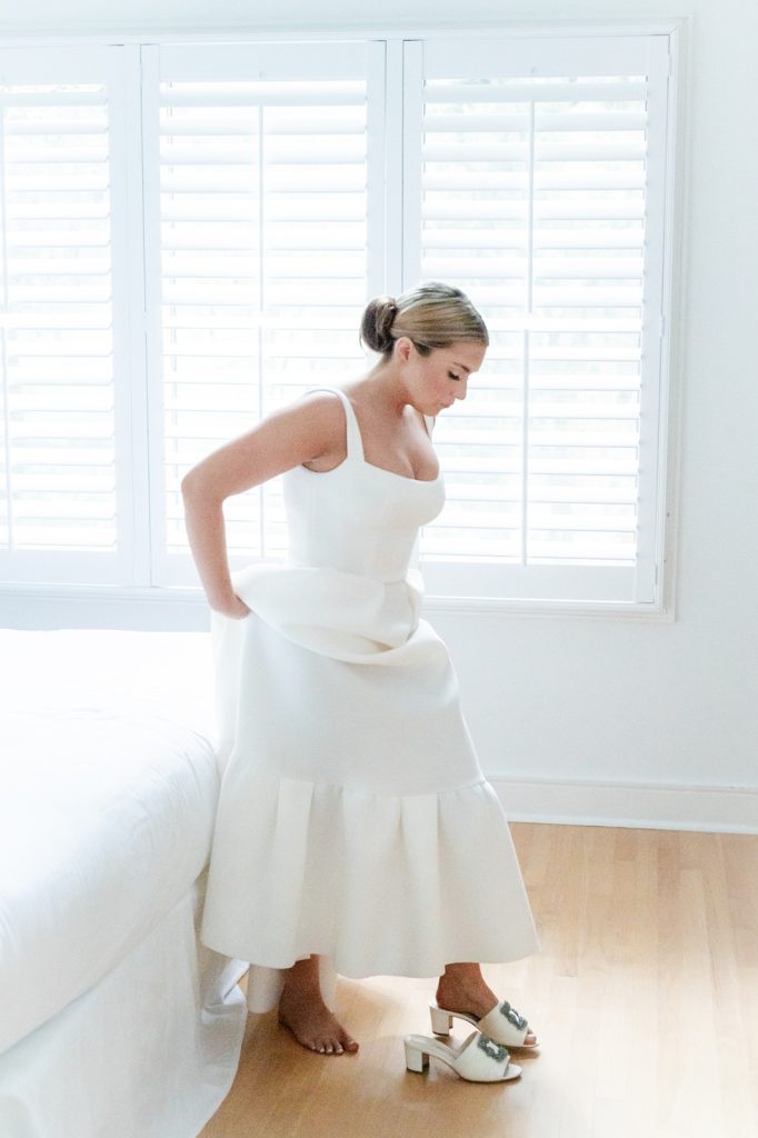 bride stepping into wedding shoes