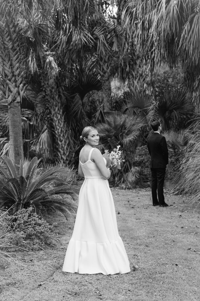 bride looking over her shoulder right before first look