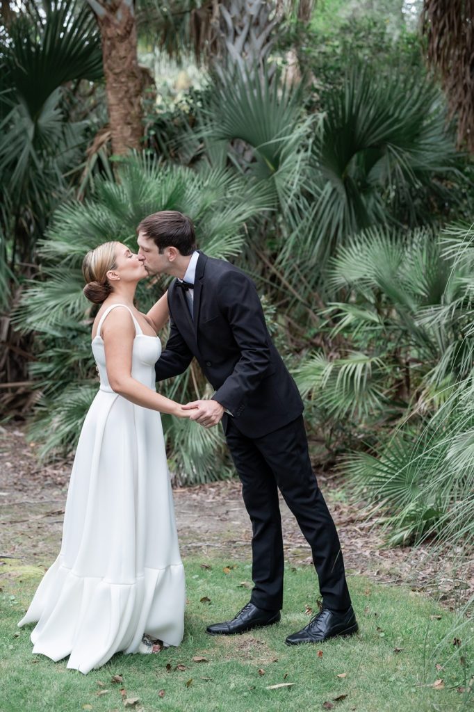 bride and groom share their first married kiss