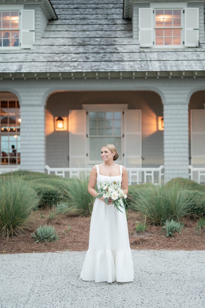 bride looking off camera in front of Kiawah Ocean Course Clubhouse