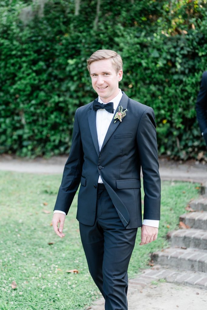 groom walking down aisle to wedding ceremony