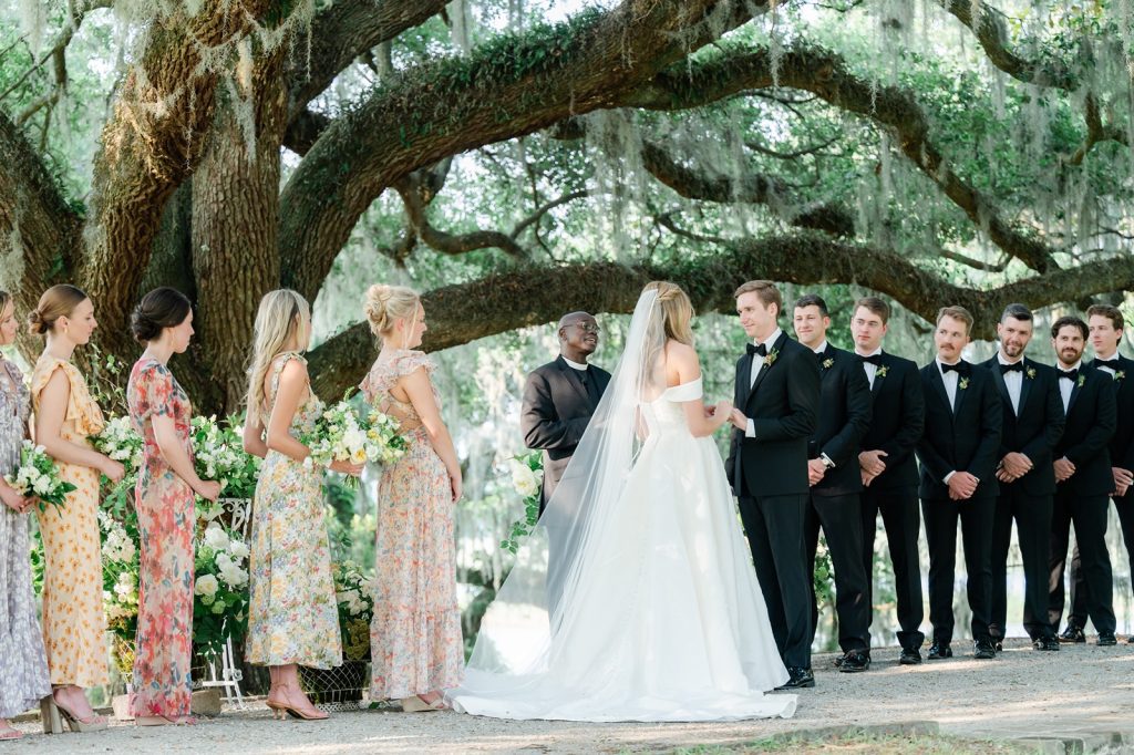 bride and groom holds hands while speaking their vows during their wedding ceremony