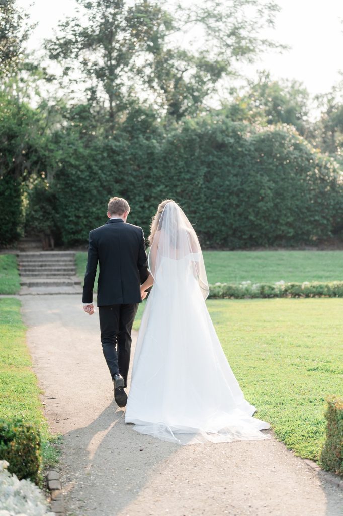 back of bride and groom walking away from wedding ceremony