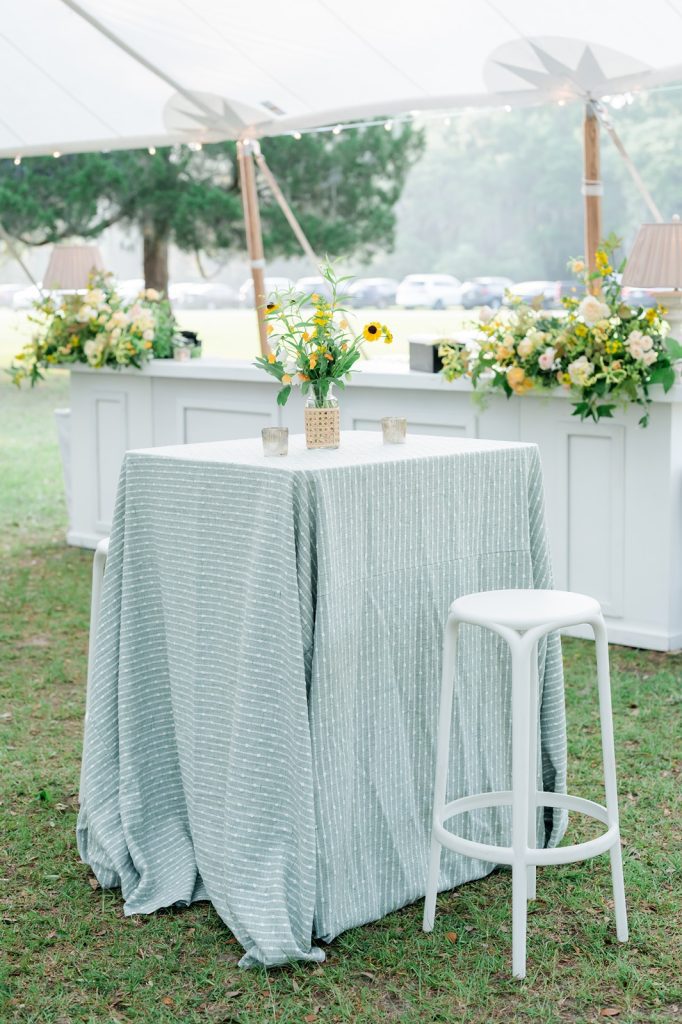 high top table with blue linen at outside wedding reception