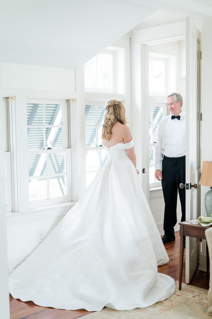 Father of the bride has first look with daughter in wedding dress