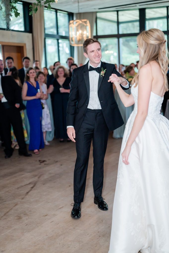 groom smiles at bride during their first dance