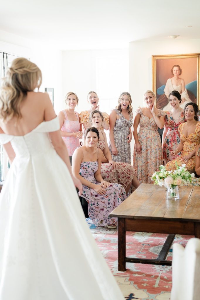 bridesmaids have first look of bride in her wedding dress