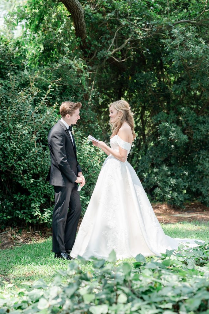 bride reads vows to groom in garden