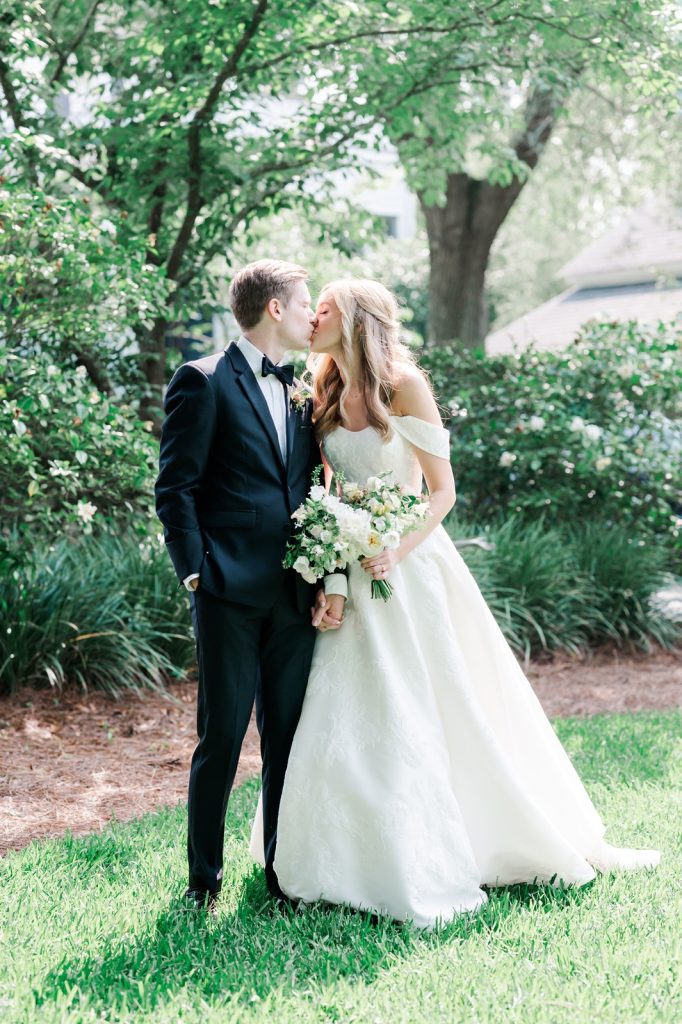 bride and groom kiss in garden