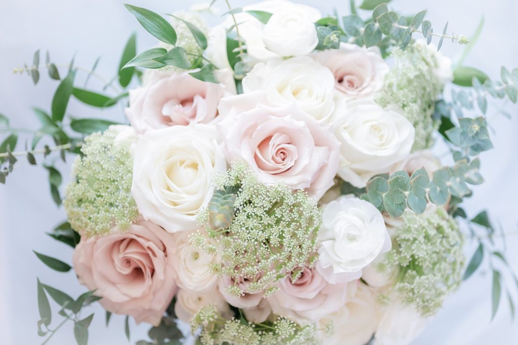 close up of bride's bouquet with pink and white roses