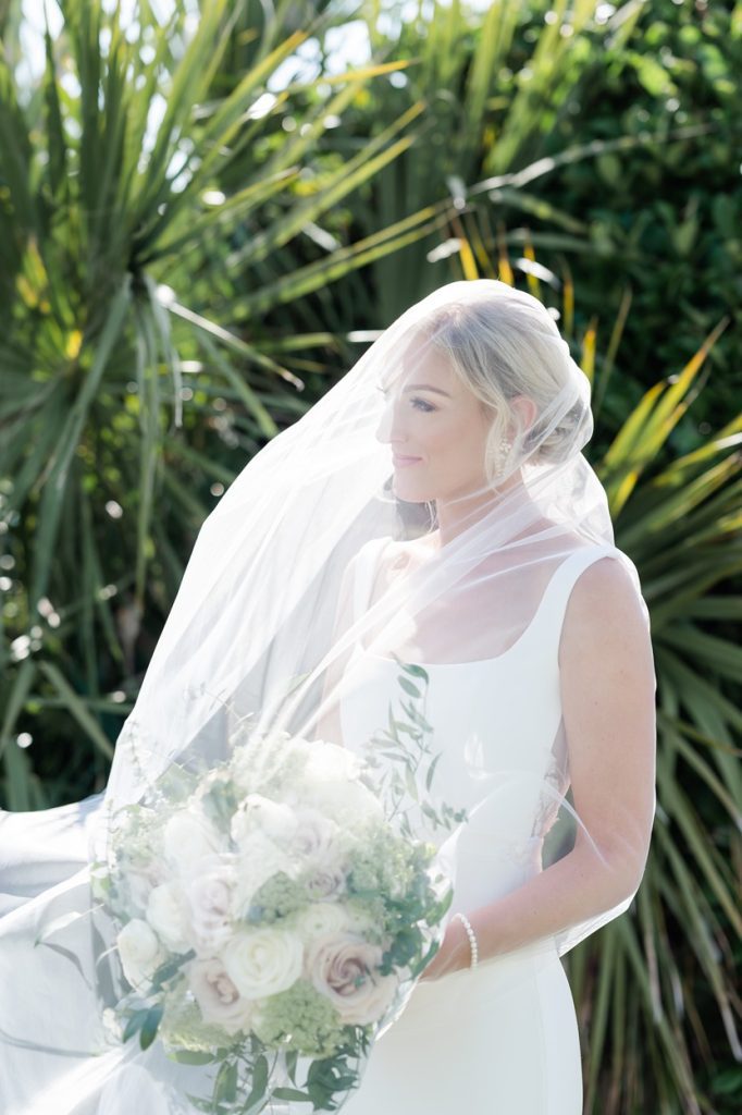 bride looking off camera with veil over her head