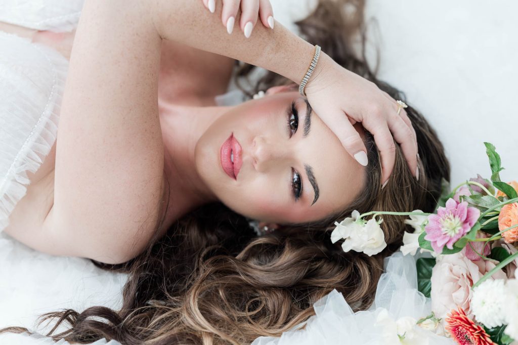 bride laying down with hand in hair
