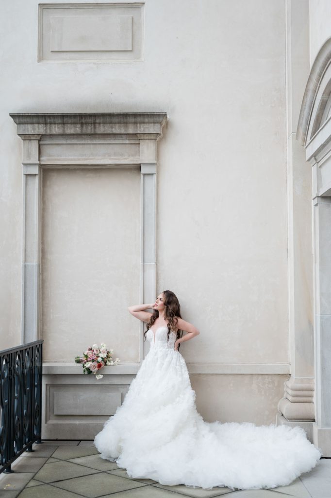 bride leaning against wall looking out