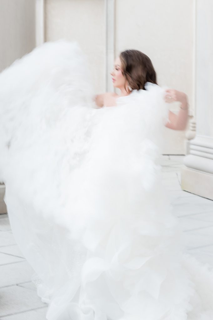 unfocused picture of bride fluffing dress