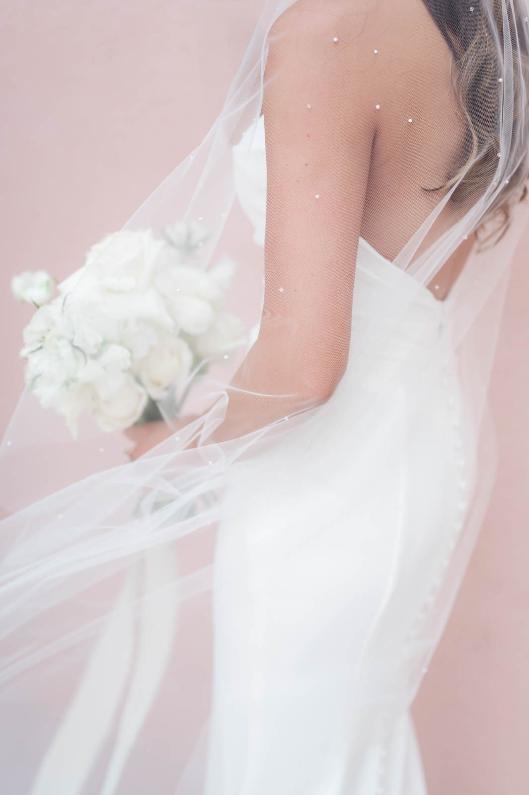 detail shot of wedding dress and veil with pearls