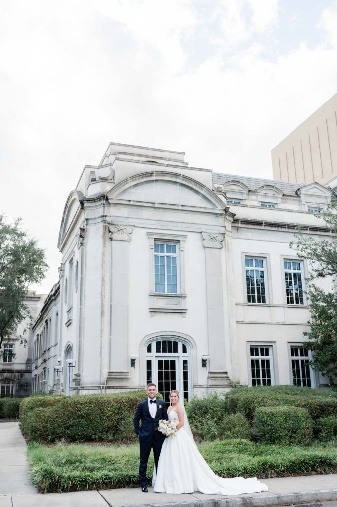 Newlyweds stand in front exterior of Gaillard center