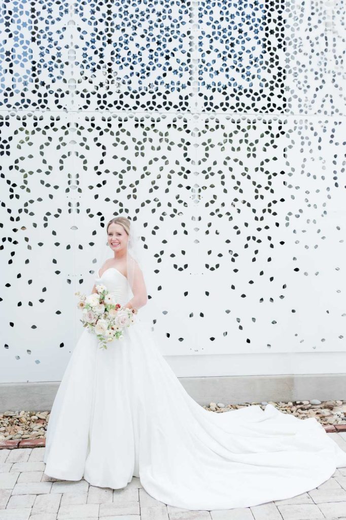 full length bridal portrait in front of white background with laser cut outs
