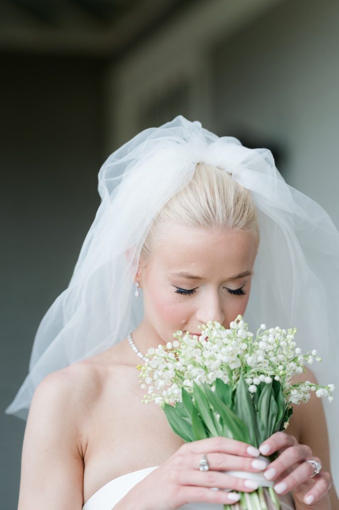 bride sniffing her bridal bouquet