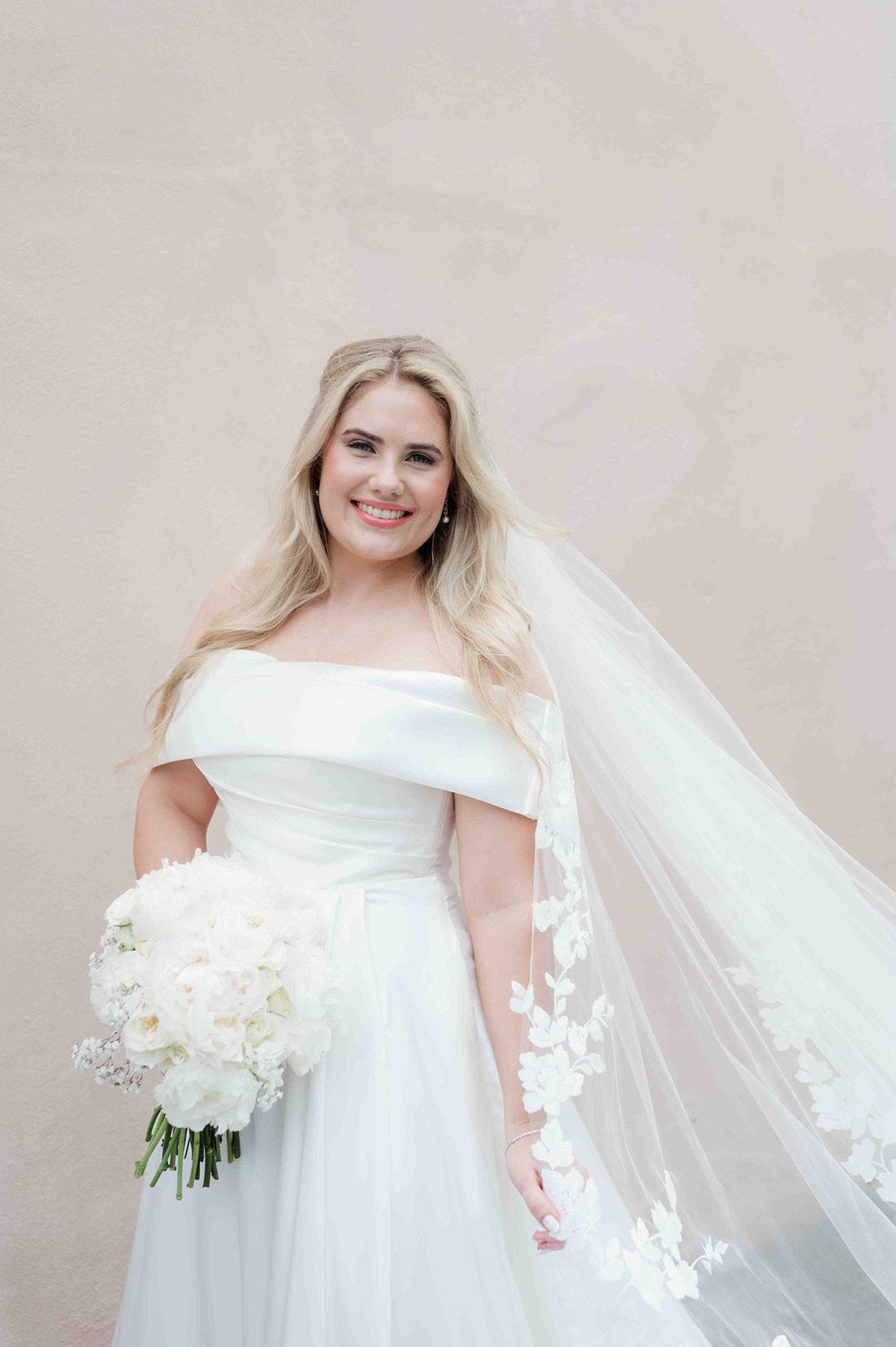 bridal portrait in front of pink wall