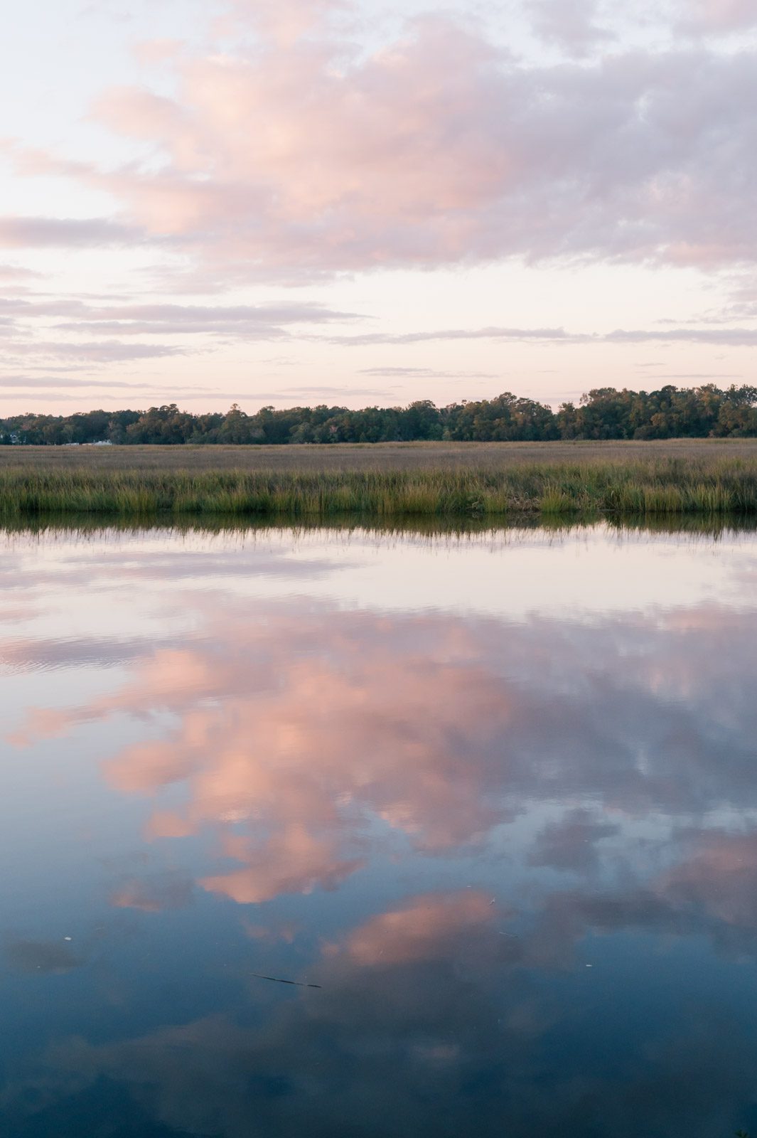sunset over the marsh with the sky reflecting in the water
